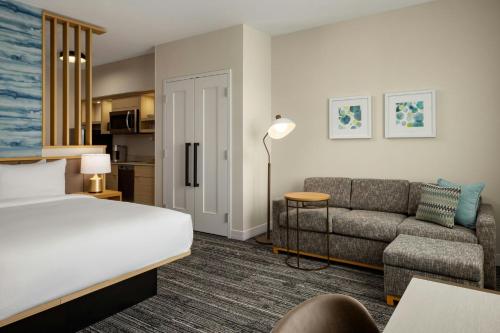 a hotel room with a bed and a couch at TownePlace Suites by Marriott Chilliwack in Chilliwack