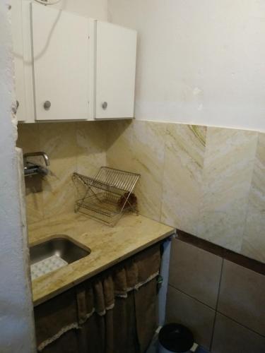 a kitchen with a sink and a counter top at Alojamiento Libertador in Alta Gracia