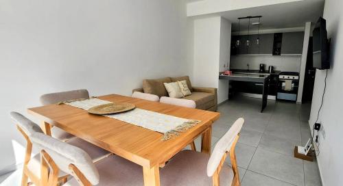a dining room table and chairs in a living room at Alojamiento Mavic - Amueblados Comahue in Cipolletti