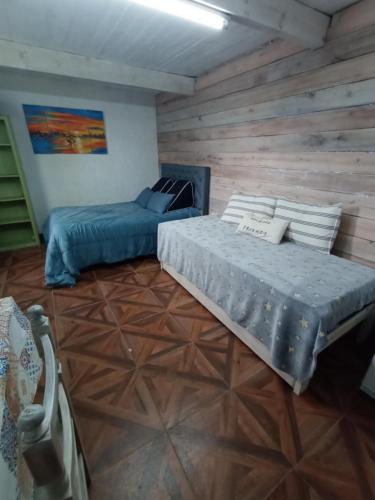 a bedroom with two beds and a couch in it at Monoambiente Loft La Tranquilidad in Mar del Tuyú