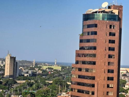 a tall building with a clock on top of it at Quarto Vista Mar in Recife