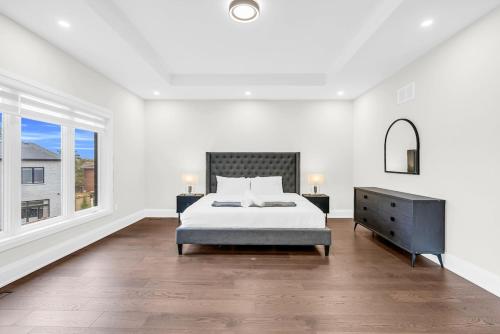 a white bedroom with a bed and a window at Welcome to Your Comfort Retreat by the Lake in Burlington