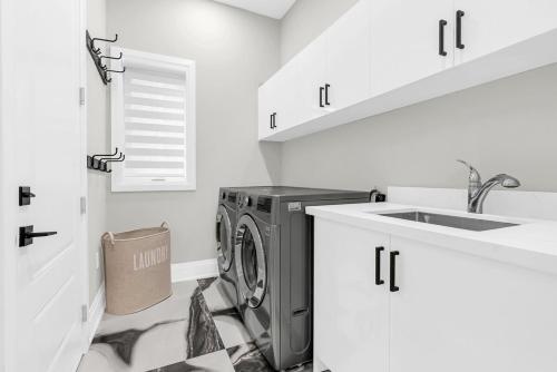 a laundry room with a washing machine and a sink at Welcome to Your Comfort Retreat by the Lake in Burlington