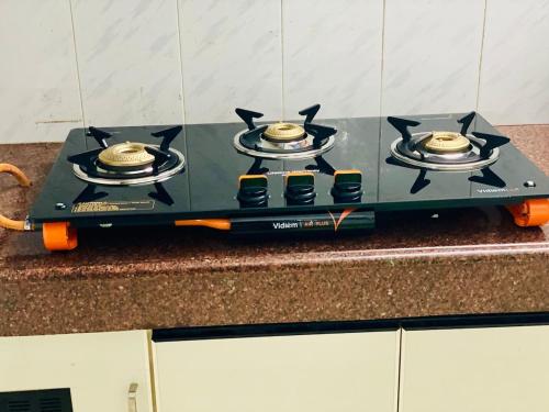 a stove with four burners on top of a counter at Stay with Palee By Casa Paleo in Trivandrum