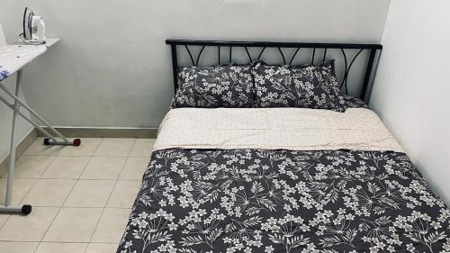 a bed with a black and white blanket and pillows at Stay with Palee By Casa Paleo in Trivandrum