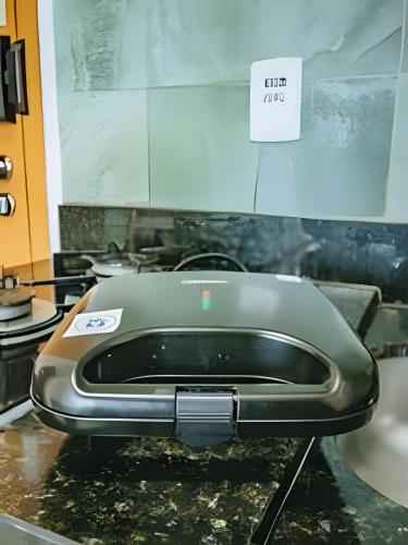 a toaster sitting on a counter with a sign on it at Apartment with incredible views, 10 meters from the beach in Porto De Galinhas