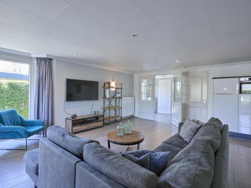 a living room with a large couch and a tv at t Kaatsheuveltje 4 in Kaatsheuvel