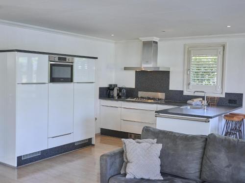 a living room with a couch and a kitchen at t Kaatsheuveltje 4 in Kaatsheuvel