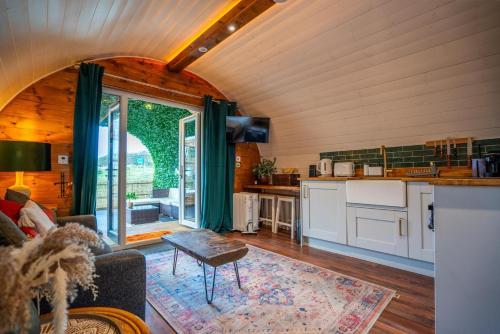 a kitchen and living room in a house at Coorie Retreats Luxury Geo Domes and Cabins with Private Hot Tubs Cinema Firepit Spa and More in Portpatrick