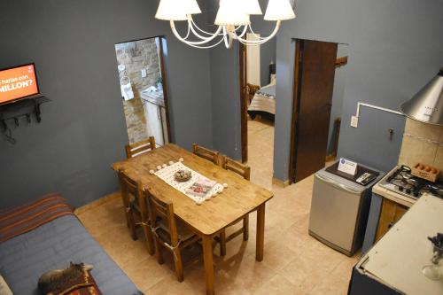 a dining room with a table and a couch at Hotel Cabañas Aparts Tierra de Glaciares in El Calafate