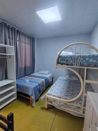 a room with two beds and a bunk bed at Casa Ríos 