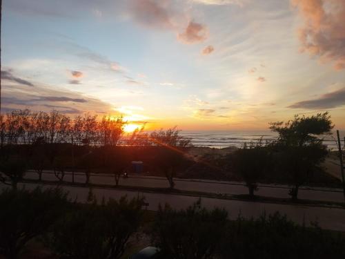a sunset from the balcony of a condo at Beachfront apartment, exclusive view! in Xangri-lá