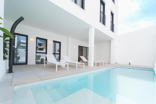 an image of a swimming pool in a house at Valencia Living Suites in Picanya