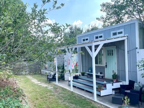 a tiny house with a porch and a patio at Tiny house on Flower Farm in downtown Atlanta in Atlanta
