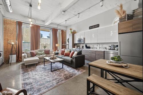 a living room with a couch and a table at Modern-Chic Loft in Heart of Dallas in Dallas