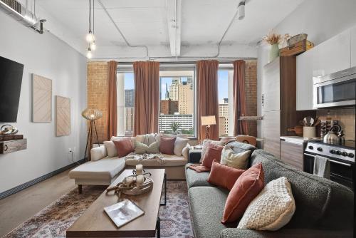 a living room with a couch and a table at Modern-Chic Loft in Heart of Dallas in Dallas