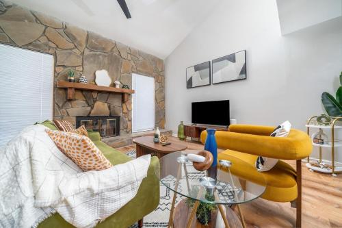 a living room with a couch and a fireplace at Heritage Haus - Luxe 2BR w Deck, Pets OK, Wi-fi, Near Marietta Sq in Marietta