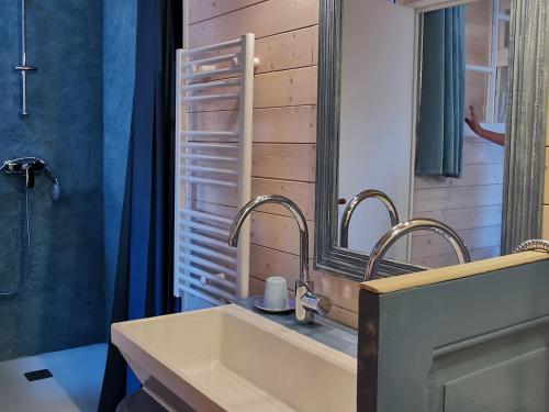 a bathroom with a sink and a mirror at Maison cosy avec cour privative au cœur de l'Auvergne - FR-1-582-316 in Lempdes sur Allagnon