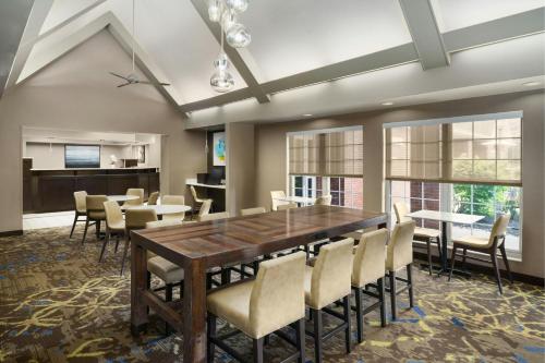 a dining room with a large wooden table and chairs at Residence Inn by Marriott Portland Scarborough in Scarborough