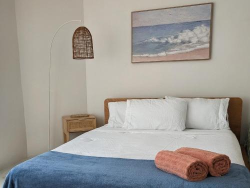 a bedroom with a bed with a towel on it at Peaceful, Walk to Beach, Bikes, AC, Starlink in Byron Bay