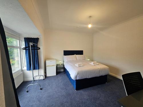 a hotel room with a bed and a window at Airport Lodge in Sheldon