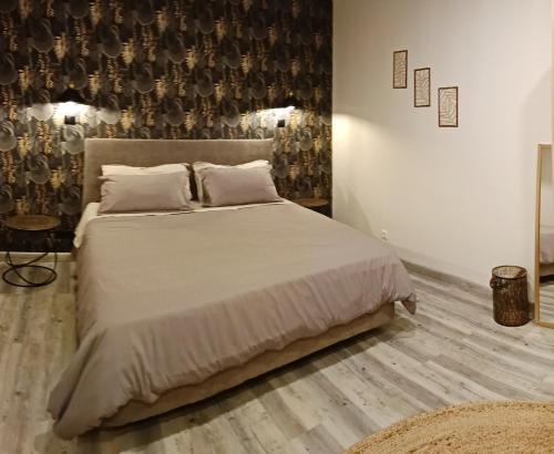 a bedroom with a large bed with white sheets and pillows at HomeLand Place AL in Horta