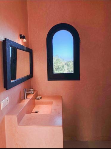 a bathroom with a sink and a window at Villa Lala Argana in Essaouira
