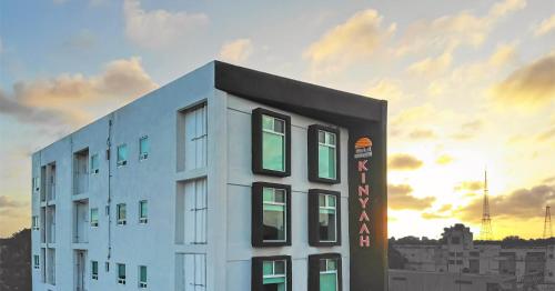 a white building with a sunset in the background at Hotel Kinyaah in Mérida