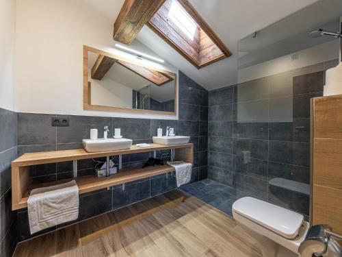 a bathroom with two sinks and a mirror at Apartment near Jochberg ski lift in Jochberg