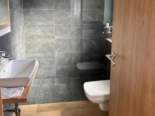 a bathroom with a white toilet and a sink at Apartment with ski-storage, parking in Jochberg
