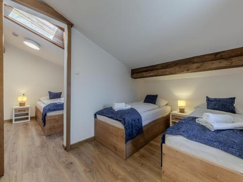 a bedroom with two beds and a mirror at Apartment in Jochberg on ski-slope in Jochberg