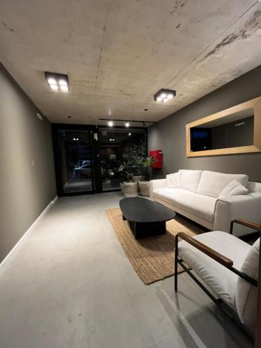 a living room with a white couch and a table at Link in Montevideo