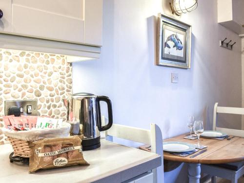 a kitchen with a table with a blender on it at Sea Dog Cottage - Uk42479 in Whitby