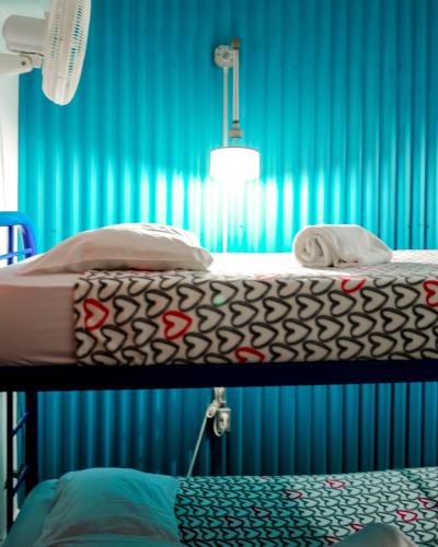a hospital room with two bunk beds in front of a blue curtain at Hostel Posada 1914 in Panama City