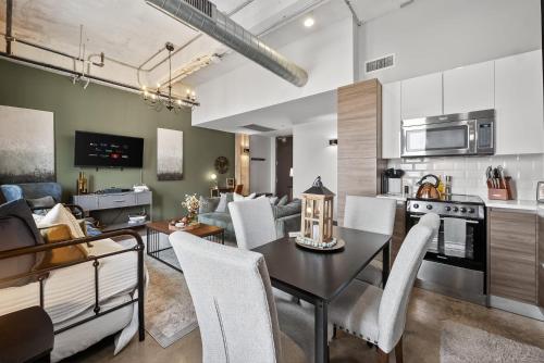 a kitchen and living room with a table and chairs at Stylish Vintage Loft in Dallas