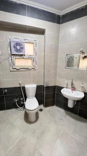 a bathroom with a toilet and a sink at Negmet Siwa Hotel in Siwa