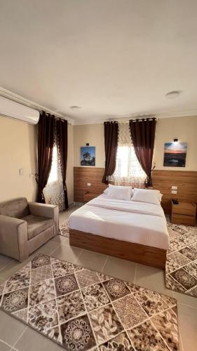 a large bedroom with a large bed and a couch at Negmet Siwa Hotel in Siwa