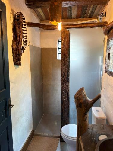 a bathroom with a white toilet and a sink at Casa Ar Fresco in Sapiranga