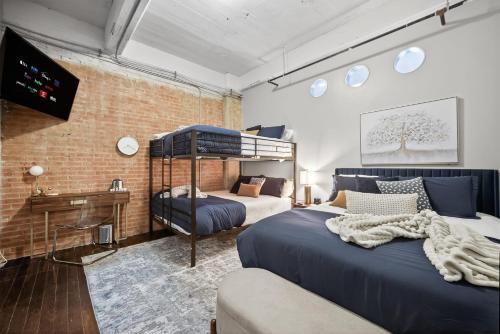 a bedroom with two beds and a television in it at Urban Luxe Loft in Dallas