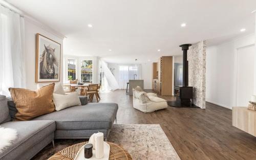 a living room with a couch and a table at 10 min walk to beach and cafés, Quiet area, Bikes in Byron Bay