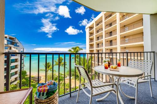 a balcony with a table and chairs and a view of the ocean at Oceanfront Kahana Condo Ocean View, Beachfront, Pool & Sleeps 4, Walkable Area in Lahaina