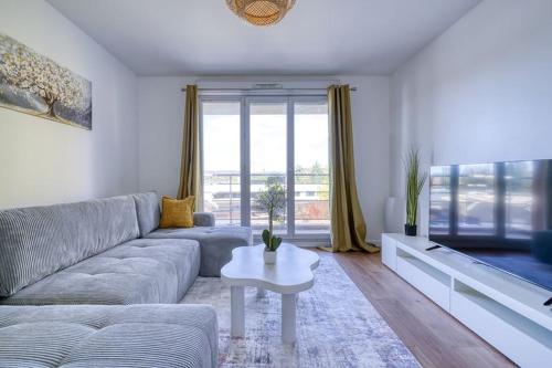 a living room with a couch and a table at Canal de Yvette in Longjumeau