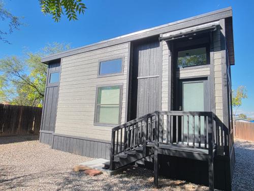 a tiny house with a porch and a door at Luxurious Tiny Home 15 Minutes from Sedona! #25 in Cottonwood