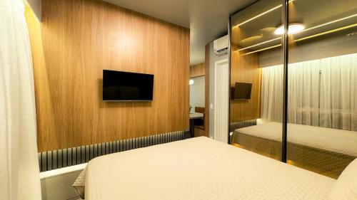 Ένα ή περισσότερα κρεβάτια σε δωμάτιο στο O mais novo e aconchegante da cidade