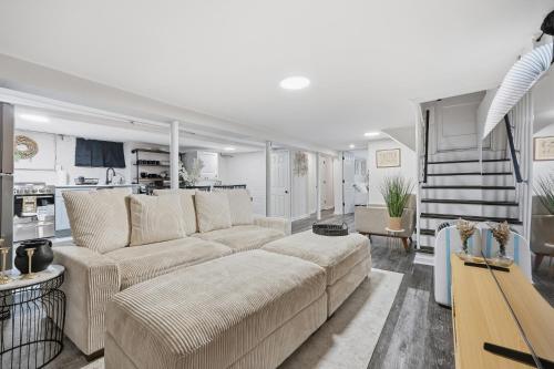 a living room with a couch and a kitchen at Airport Haven - Cozy 2BR Apt 5 Min Away in Newark