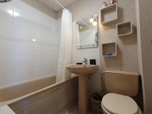a bathroom with a toilet and a sink and a tub at Maisonnette confortable proche plage, 4 pers, parking privé - FR-1-476-203 in La Faute-sur-Mer