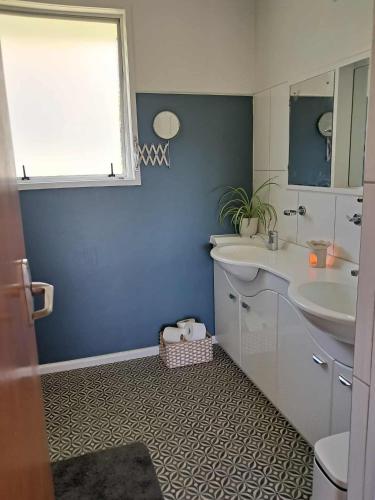 a bathroom with a sink and a mirror at Turanga Heights in Gisborne