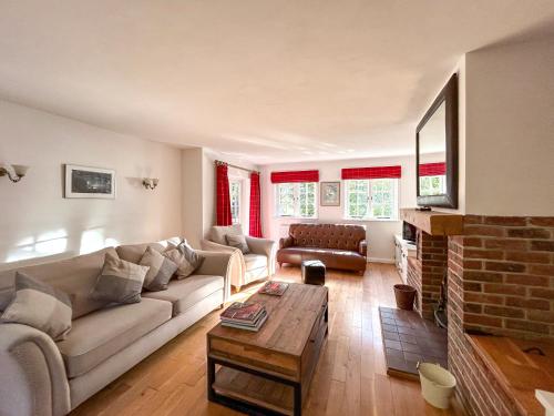 a living room with a couch and a table at The Cottage - Uk50673 in Tangmere