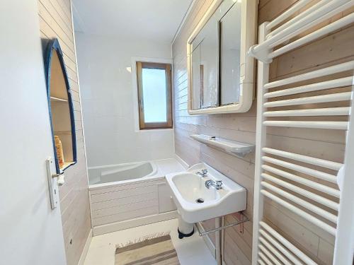 a bathroom with a sink and a bath tub at Maison de vacances à 20m de la plage, jardin clos, Wi-Fi, idéale famille - FR-1-361-163 in Jullouville-les-Pins