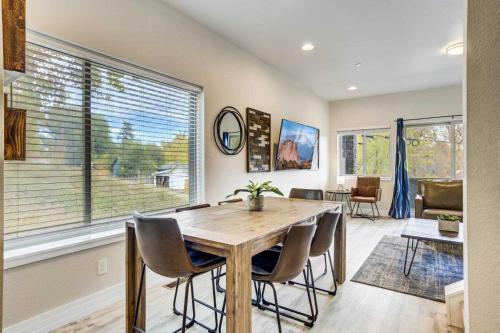 a dining room with a wooden table and chairs at 4BD Home w Rooftop Patio Fire Pit & Mountain Views in Colorado Springs
